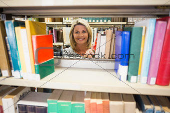 Mature student taking a book in library
