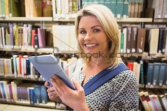 Mature student using tablet in library