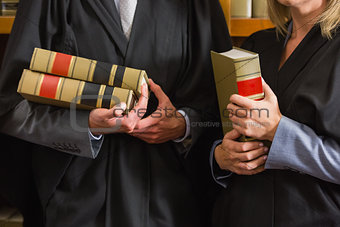 Lawyers holding books in the law library