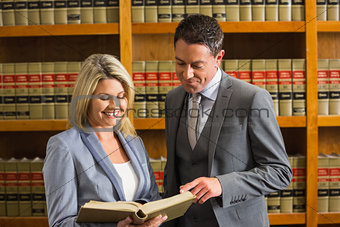 Lawyers reading book in the law library