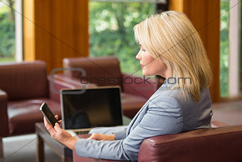 Blonde businesswoman using her phone