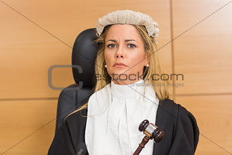 Stern judge sitting and listening