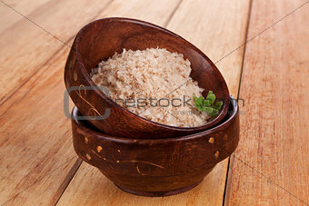 Natural salt crystal in wooden oriental bowl.