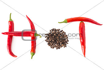 Hot word made from red hot chili pepper and peppercorn on white 