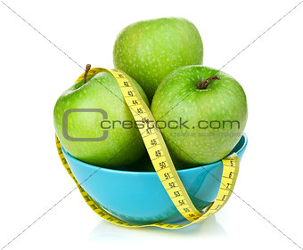 Fresh green apples with yellow measuring tape