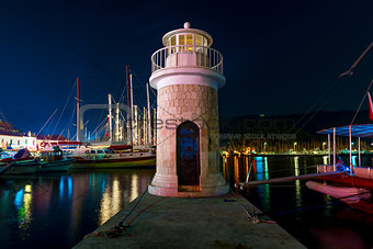 night shot of the lighthouse on the pier