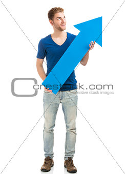 Young man holding a blue arrow