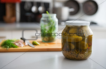 Closeup on jar of pickled cucumbers on table
