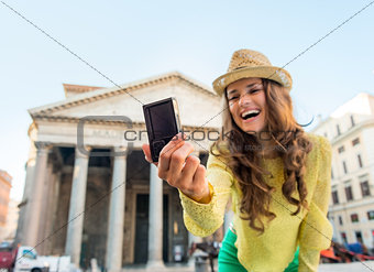 Closeup on happy young woman making selfie in front of pantheon 