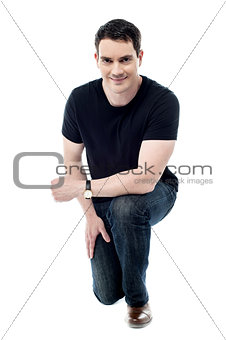 Casual man posing crouched