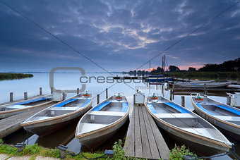 boats on lake harbor at sunrise