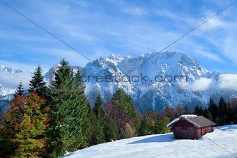 hut on snow meadow in winter Alps