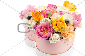 Flower bouquet in a heart shaped box isolated on white