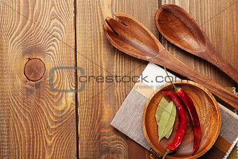 Wood kitchen utensils over wooden table background