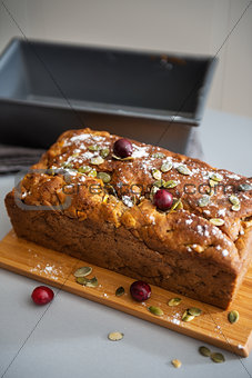 Closeup on freshly baked pumpkin bread with seeds on table