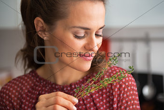 Portrait of young housewife enjoying fresh thymus