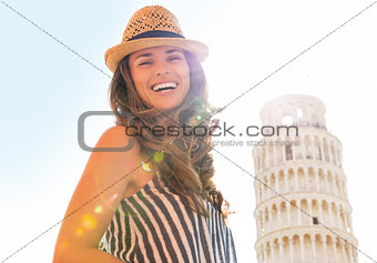 Portrait of smiling young woman in front of leaning tower of pis