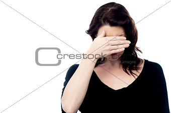 Woman covering her eyes with hand