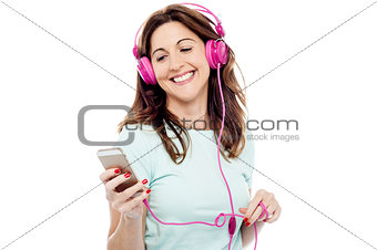 Middle aged woman enjoying listening music