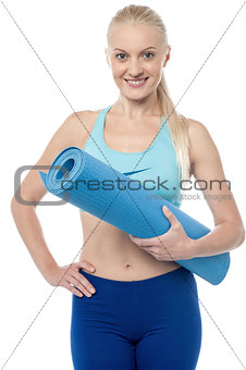 Fitness woman with an excercise mat