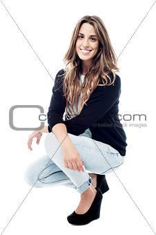 Crouching woman isolated over white