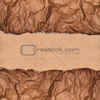 a piece of kraft paper on the background of crumpled paper