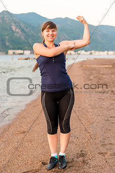 young girl athlete smiling by the sea