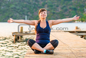 young girl with arms outstretched in the lotus position