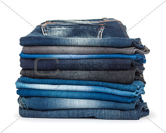 stack of different shades of blue jeans on a white background