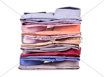 Stacks of many colored clothes isolated on a white background