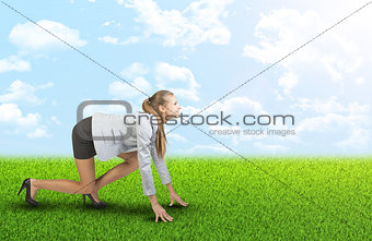 Businesswoman standing in running start pose 