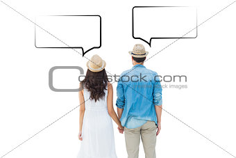 Composite image of happy hipster couple holding hands
