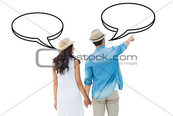 Composite image of happy hipster couple holding hands and looking