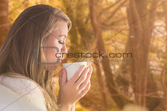 Composite image of pretty blonde relaxing on the couch with tea