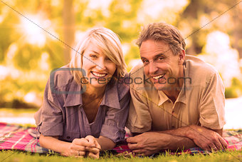 Couple lying on blanket in park