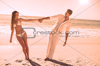 Couple holding hands and leaning to either side