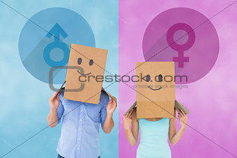 Composite image of couple wearing emoticon face boxes on their heads