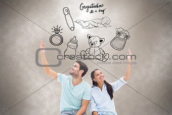 Composite image of cute couple sitting with arms raised