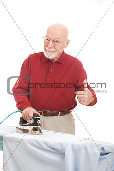 Senior Man Irons His Shirt