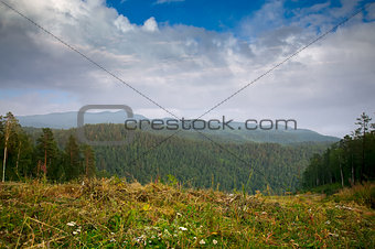 Siberian mountains, hills and forest beautiful landscape view under summer sky