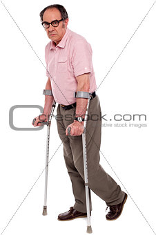 Depressed senior male with two crutches