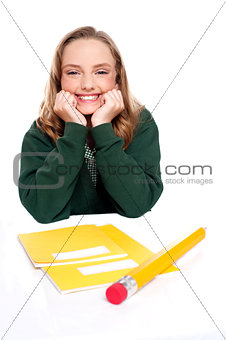 Isolated girl smiling with hands on chin