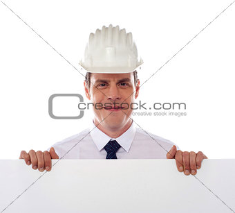 An architect holding blank white placard