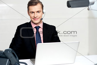 Call centre executive posing with headsets