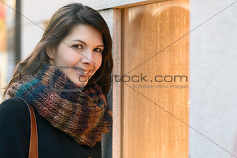 Attractive woman looking into store window