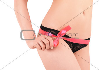 Sexy hip of a beautiful slim woman with red tape. Isolated on white background