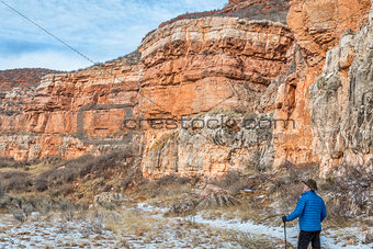hiker in sandstone canyon