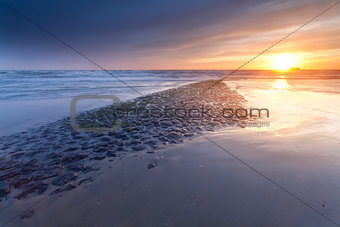 sunset over North sea coast in Netherlands