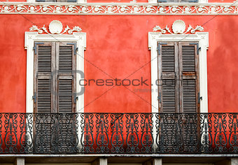Colorful Italian balcony with doors in vintage style