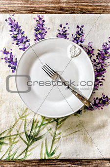 Plate and fork on vintage wooden dining table